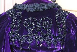 Intricate jet beading adorns the back of this purple silk velvet caplet from 1895. 